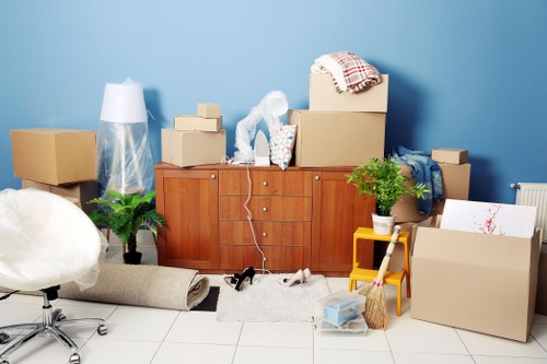 Furniture and boxes prepared for transport by movers in Malden Rushett