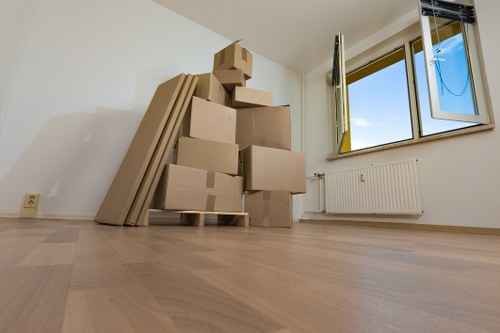 Local moving team handling boxes and furniture during a removal van job