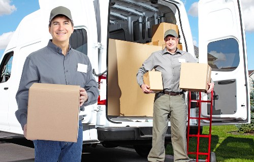 Removal team handling furniture in a rural Surrey property